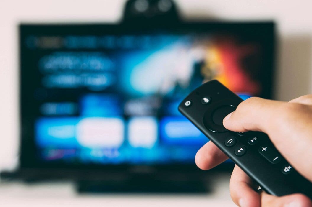 an image of a hand holding a remote control
