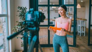 Image showing a personal trainer talking to her audience after successfully launching her fitness app.