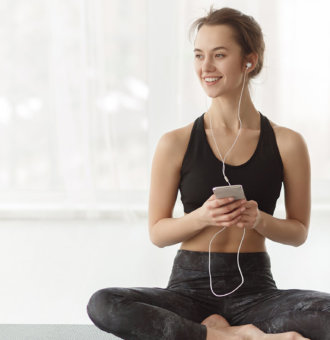 Woman Practicing yoga while listening to music