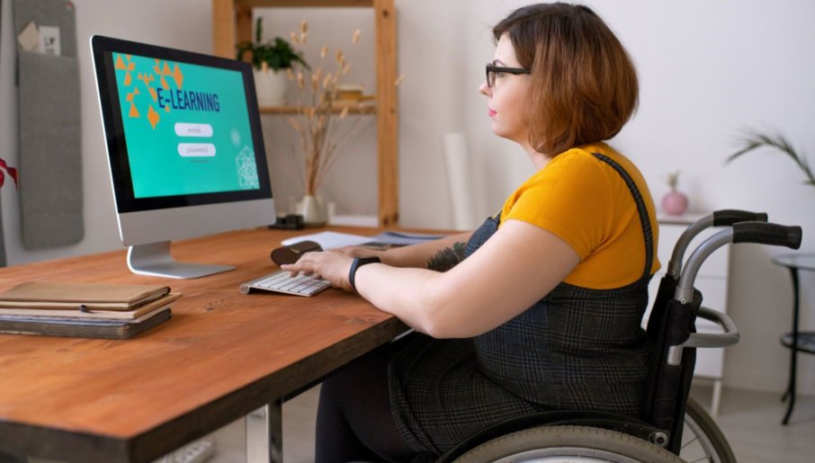 A woman using a desktop computer to research online course vs. membership site.