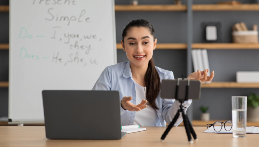 A video content creator records a video for an online course she is creating