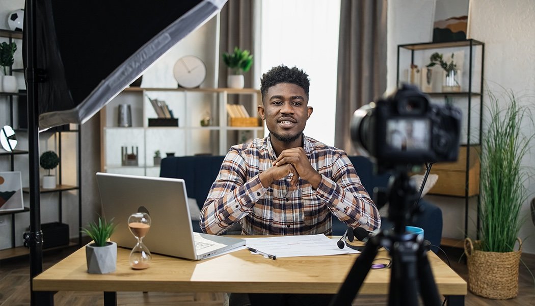 A man talks into a camera while recording his online course, indicating he selected the best online course platforms for his needs.