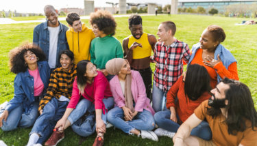 Group of young multiracial friends having fun together in the park.