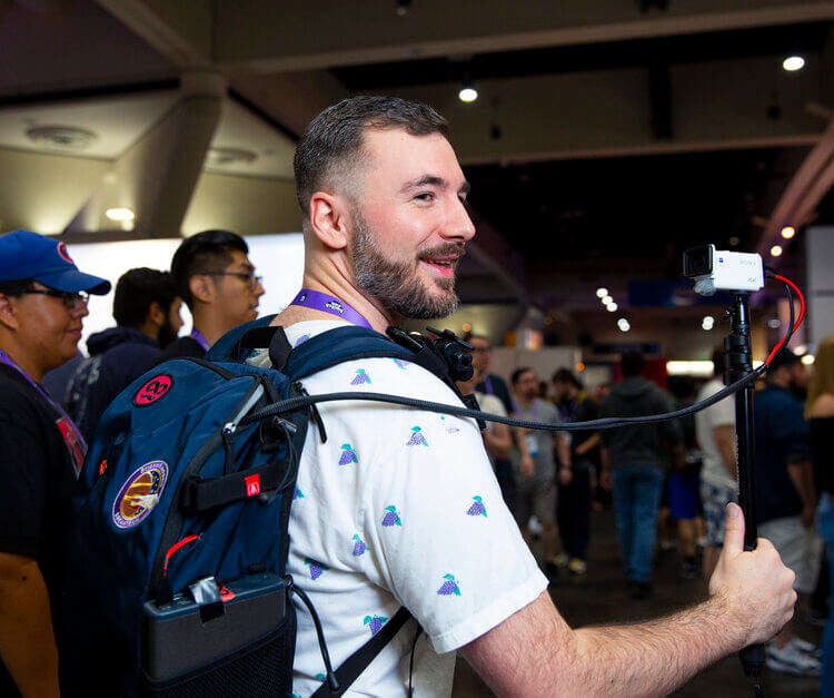 An image with a man using a special backpack for video content creation.