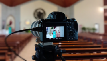 A camera live streams a church service