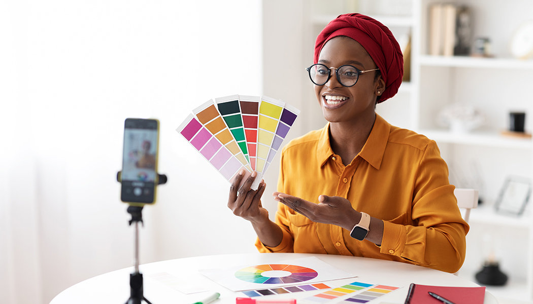 A woman records a class on color palettes using one of the top Podia alternatives.