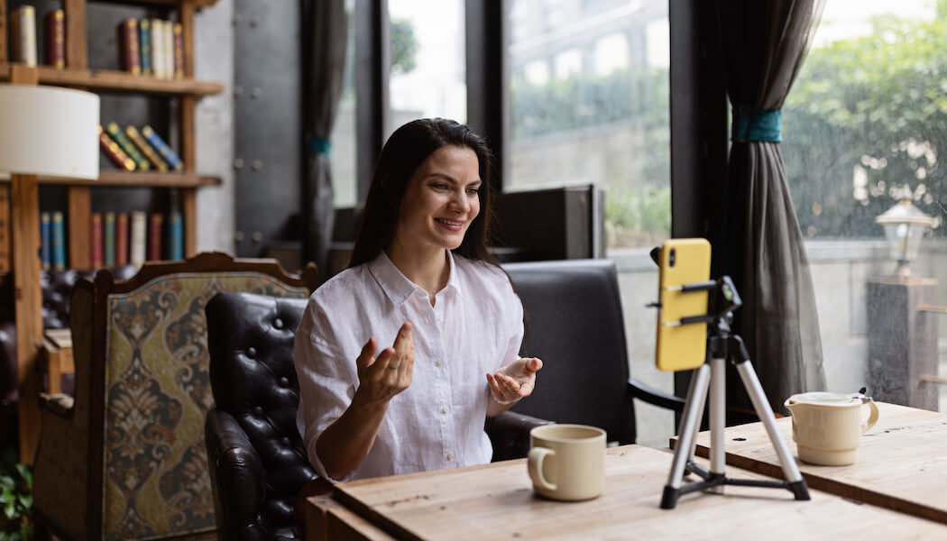 A woman talks to her audience during a live stream using Vimeo OTT alternatives.