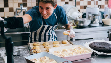 A man live streams while baking cookies and cinnamon rolls.