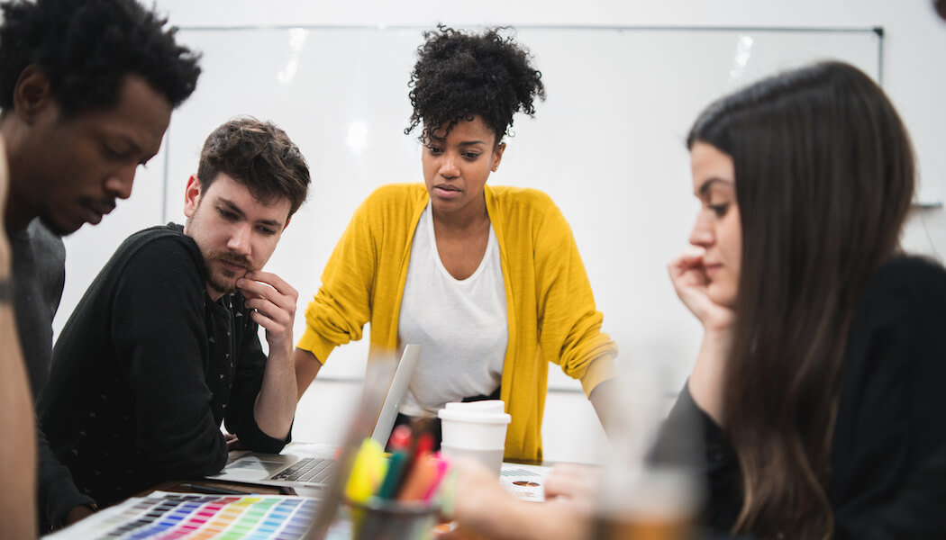 An image of a woman explaining to her team how to reduce PPC churn for their membership business.