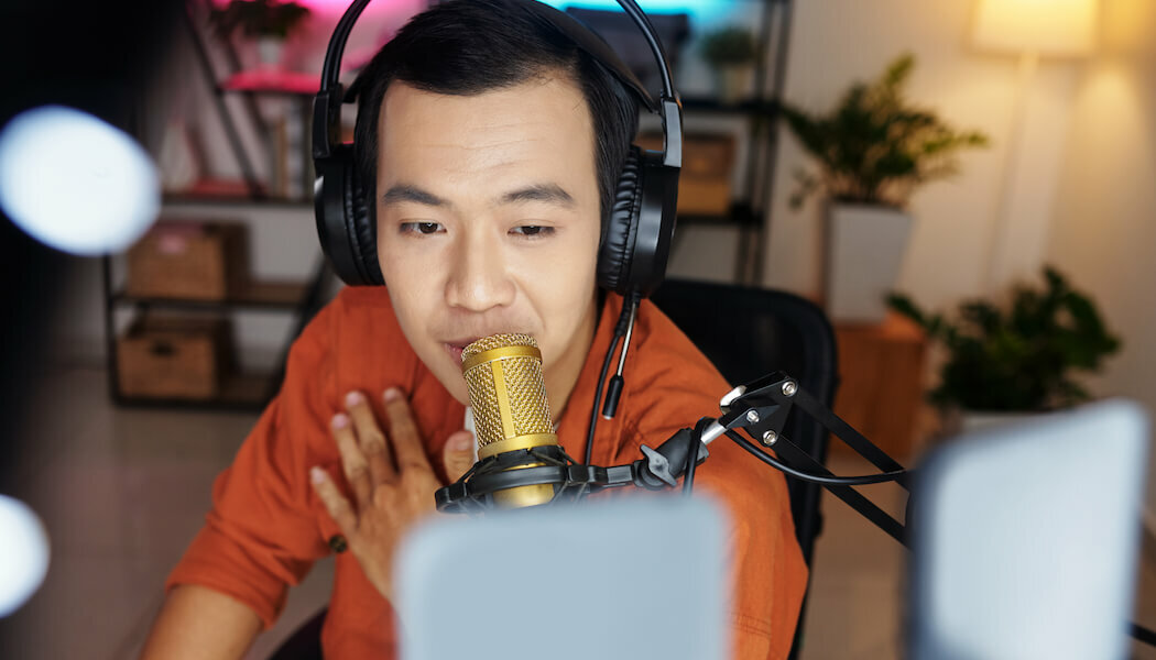 Image of a man recording premium content to sell for his video membership business.