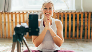 An image of woman interacting with her members after learning how to build an online community for her yoga on demand app.