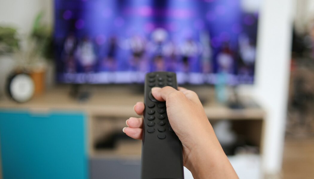 Hand Pushing Remote Control Watching TV