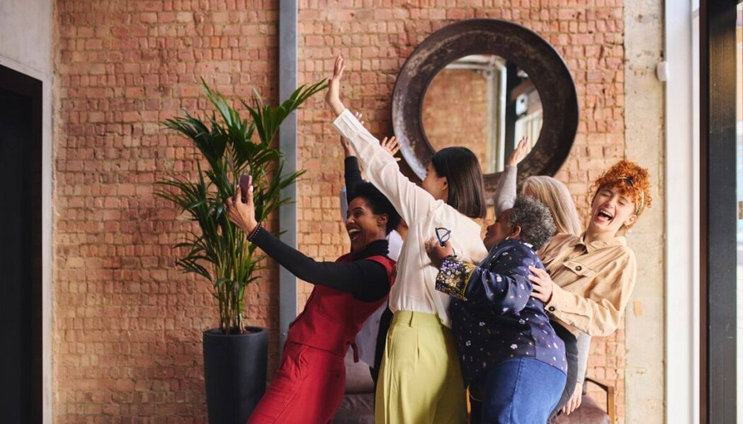 Group of women talking a celebratory selfie
