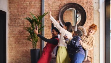 Group of women talking a celebratory selfie