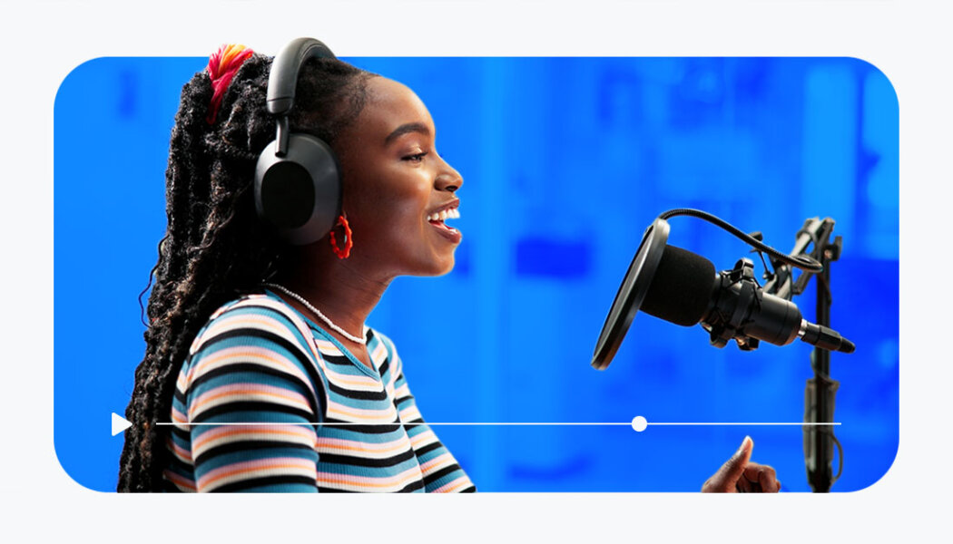 content creator streaming in front of a camera and talking into a professional mic with a stylized blue background.