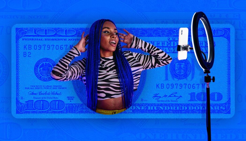 woman with blue hair posing in front of a phone and ring light.