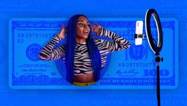 woman with blue hair posing in front of a phone and ring light.