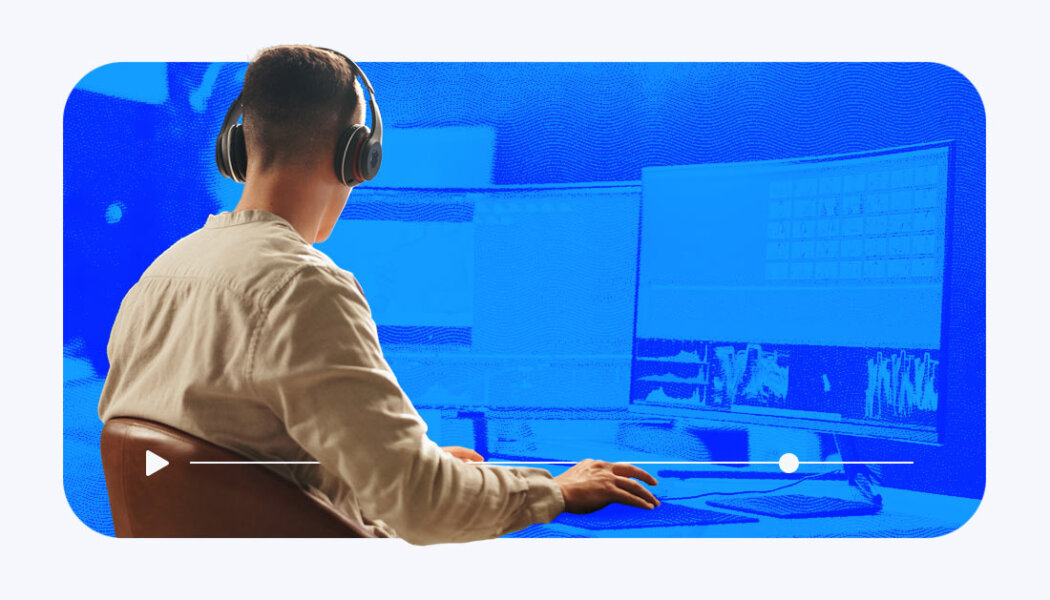 Content creator editing a video on a multi-screen creator with stylized blue effects and a play bar.